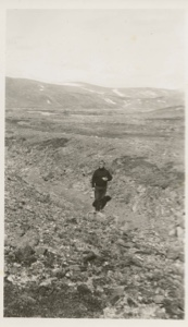 Image: Donald MacMillan walking on rough terrain